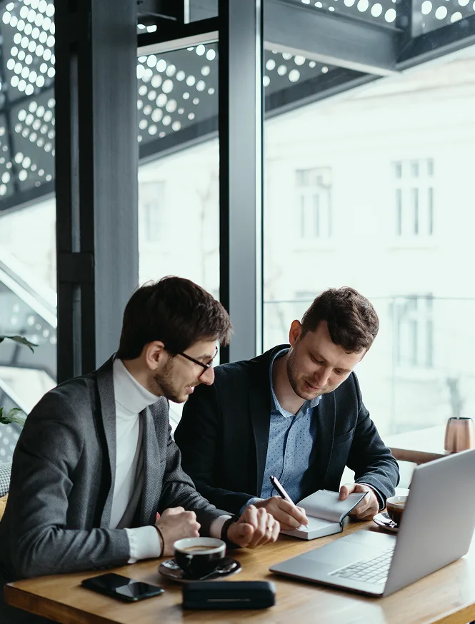 two-young-businessman-having-successful-meeting-restaurant 1